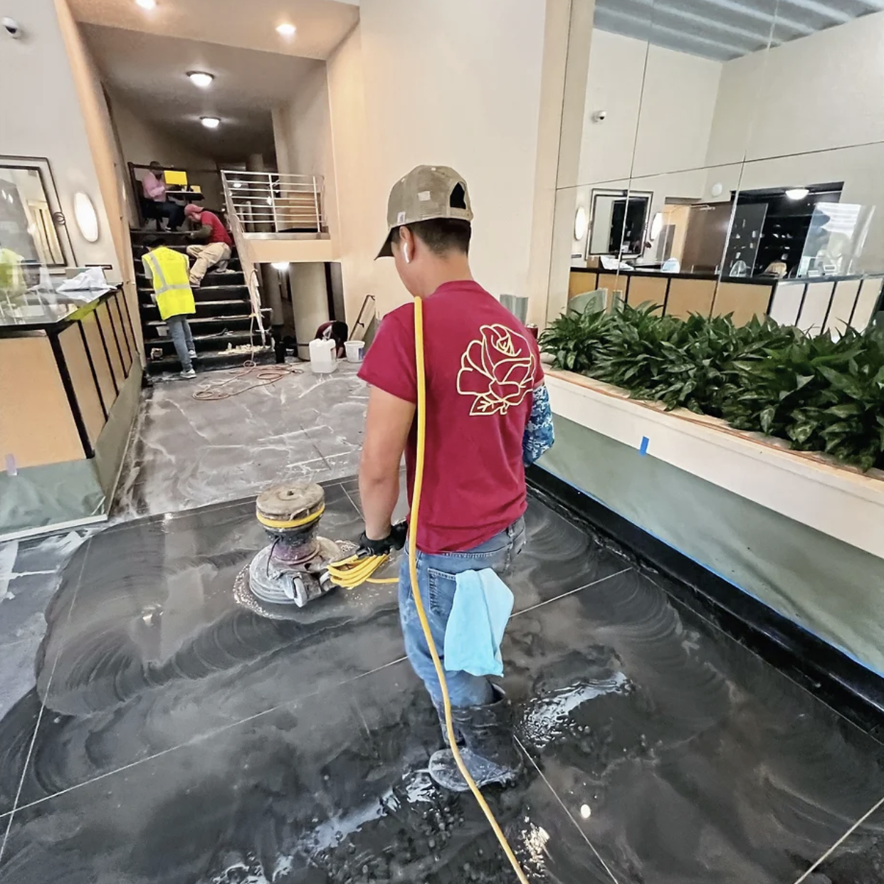 Technician polishing black stone floor