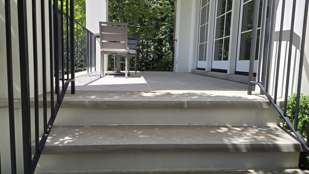 Restored concrete exterior residential staircase with iron railings by Rose Restoration