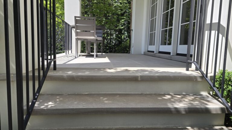 Restored concrete exterior residential staircase with iron railings by Rose Restoration