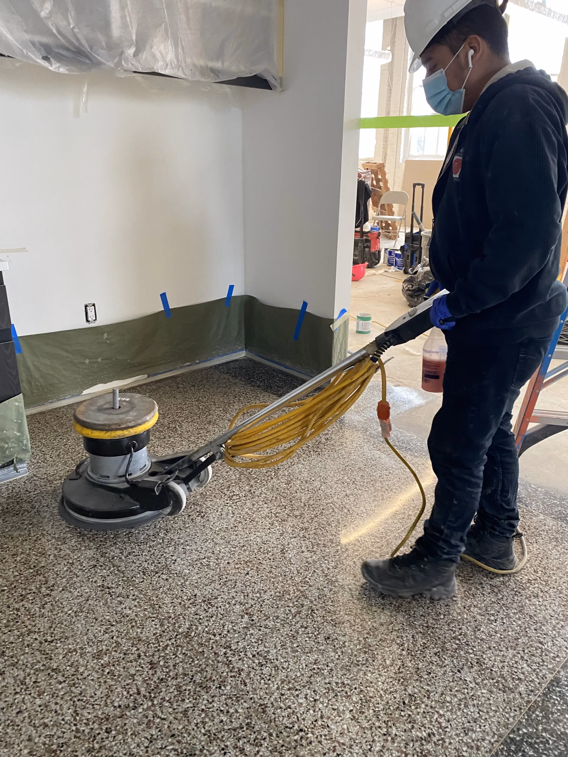 Rose Restoration technician grinding and polishing a historic terrazzo floor