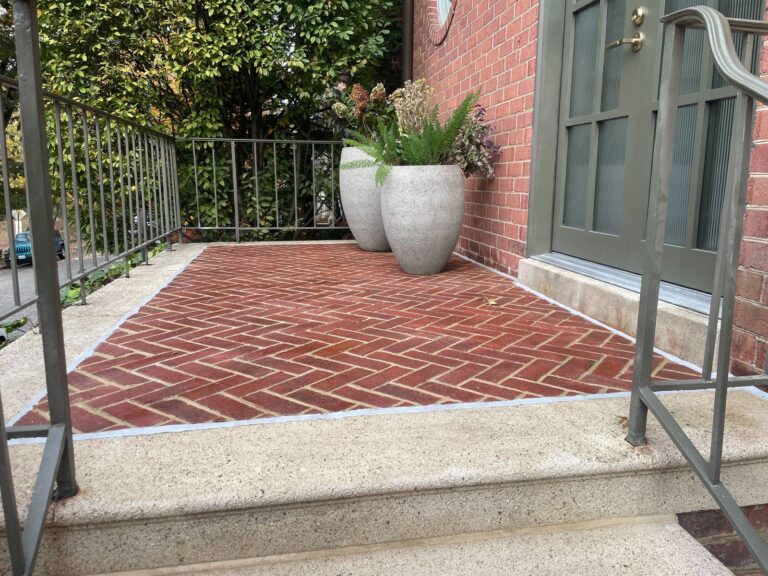 Herringbone brick residential front entry porch restored with aggregate concrete borders by Rose Restoration