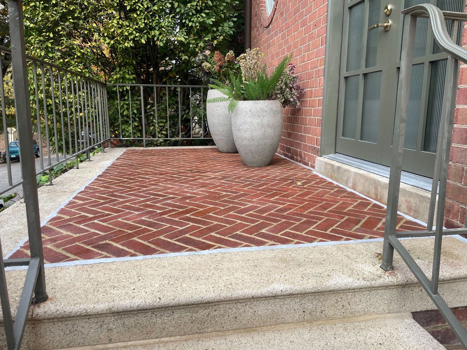 Herringbone brick residential front entry porch restored with aggregate concrete borders by Rose Restoration