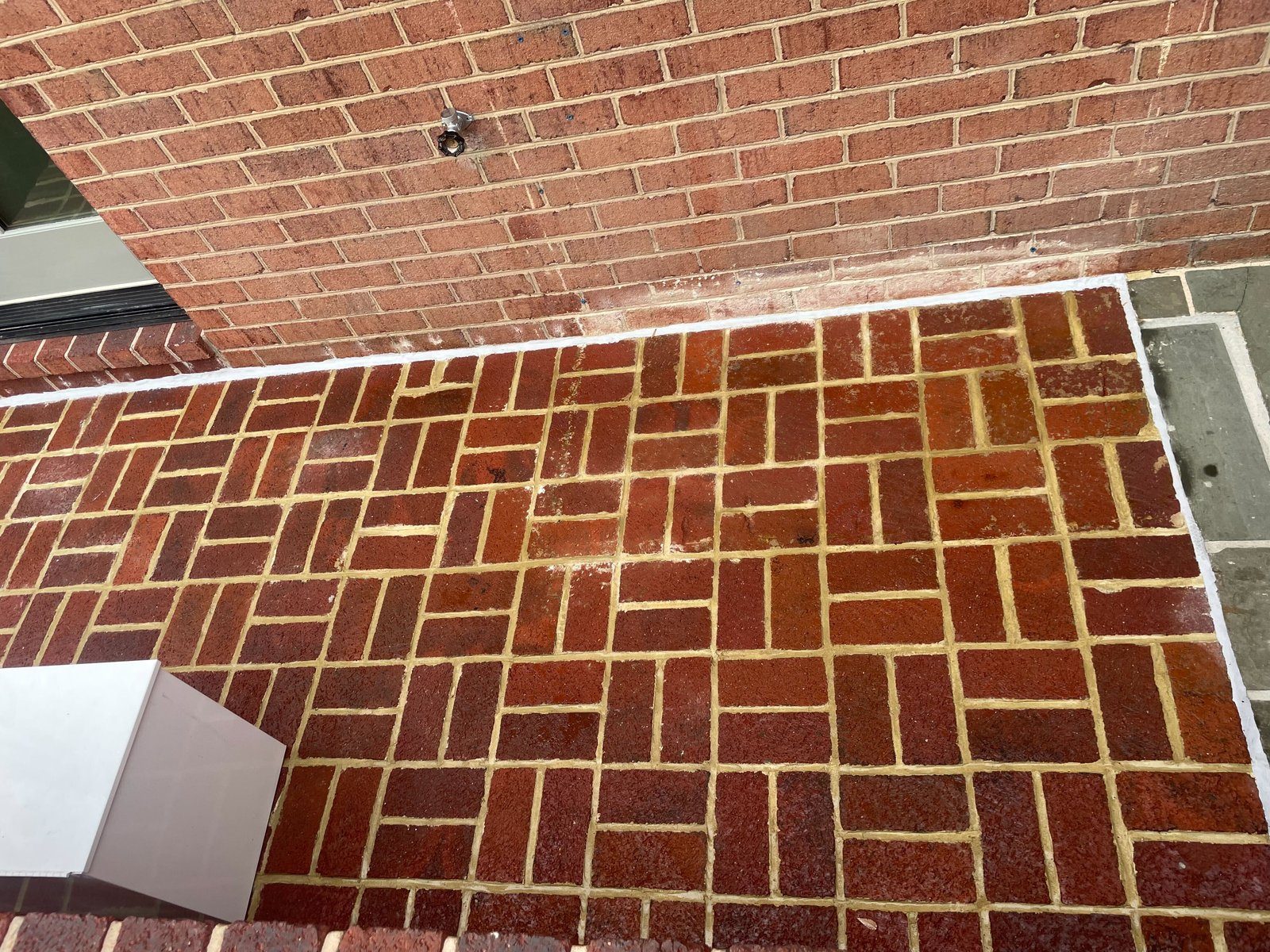 Exterior brick patio showing mortar joint restoration by Rose Restoration