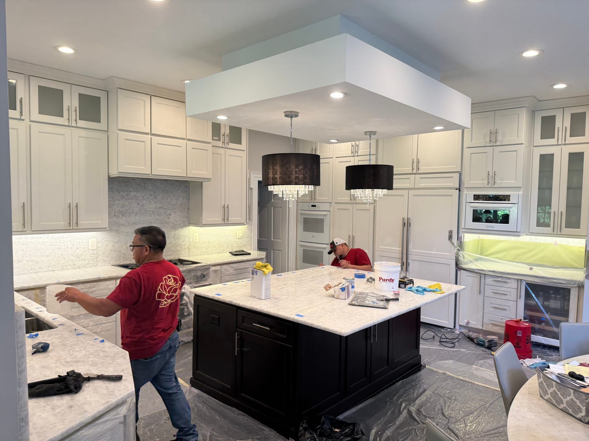 Rose Restoration technician restoring stone countertops in a residential kitchen
