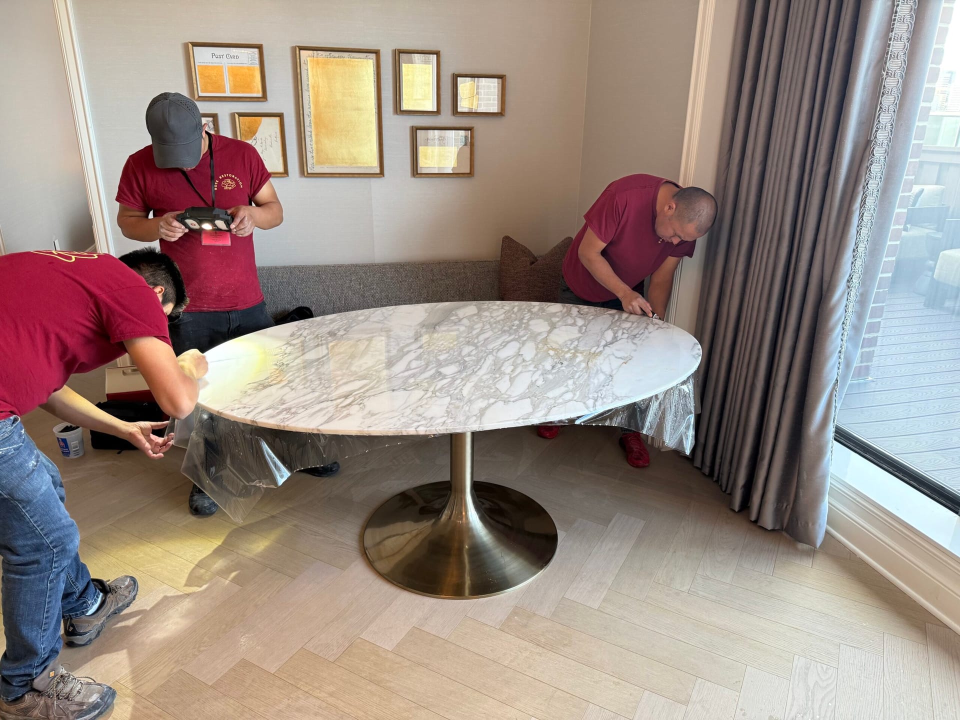Rose Restoration crew polishing a round marble table top in a residential dining room