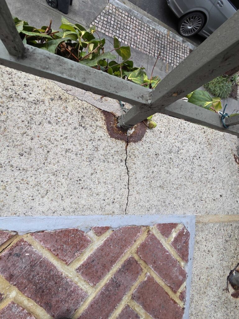 Residential exterior concrete stair landing before restoration by Rose Restoration