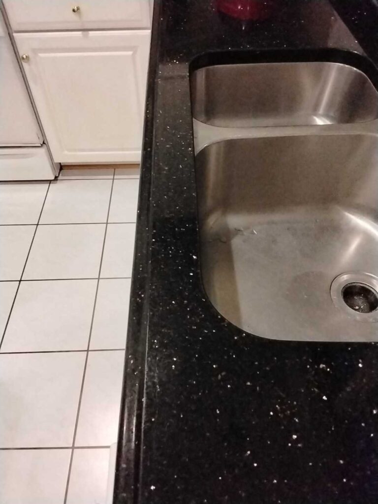 Granite kitchen countertop before professional restoration by Rose Restoration