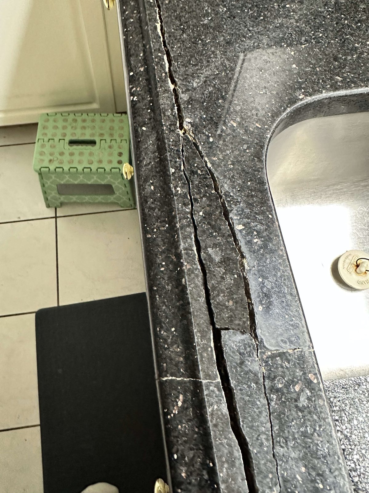 Granite kitchen countertop before restoration showing wear and stains