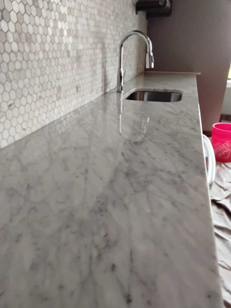 Marble Armor protective coating on Carrara marble countertop with hex tile backsplash in residential kitchen by Rose Restoration