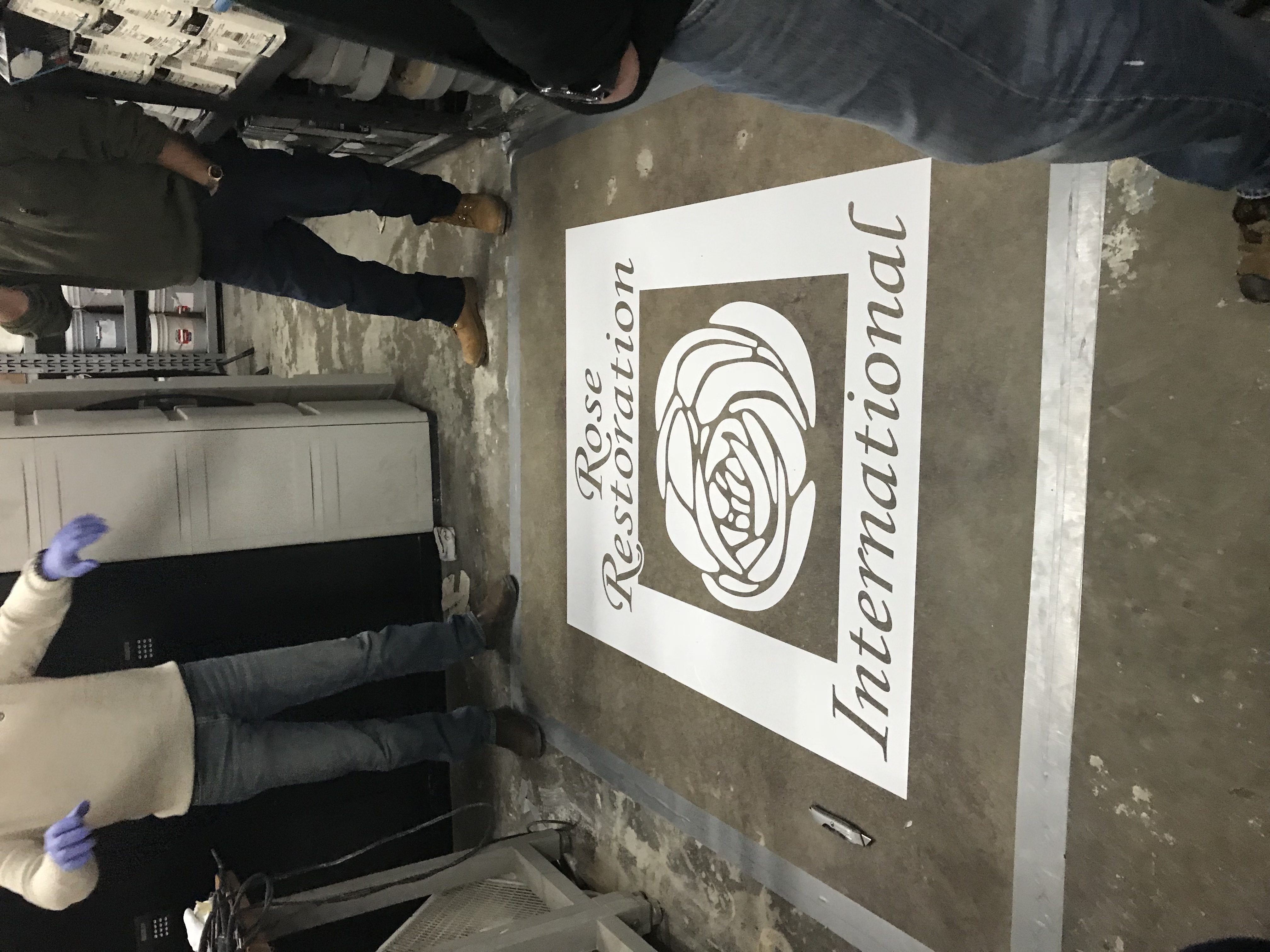 Rose Restoration International logo on polished concrete floor