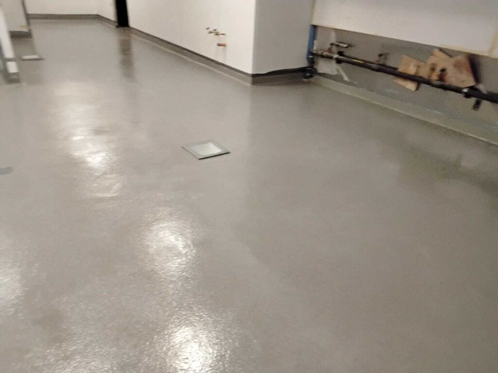 Epoxy urethane floor coating with floor drain in commercial kitchen by Rose Restoration