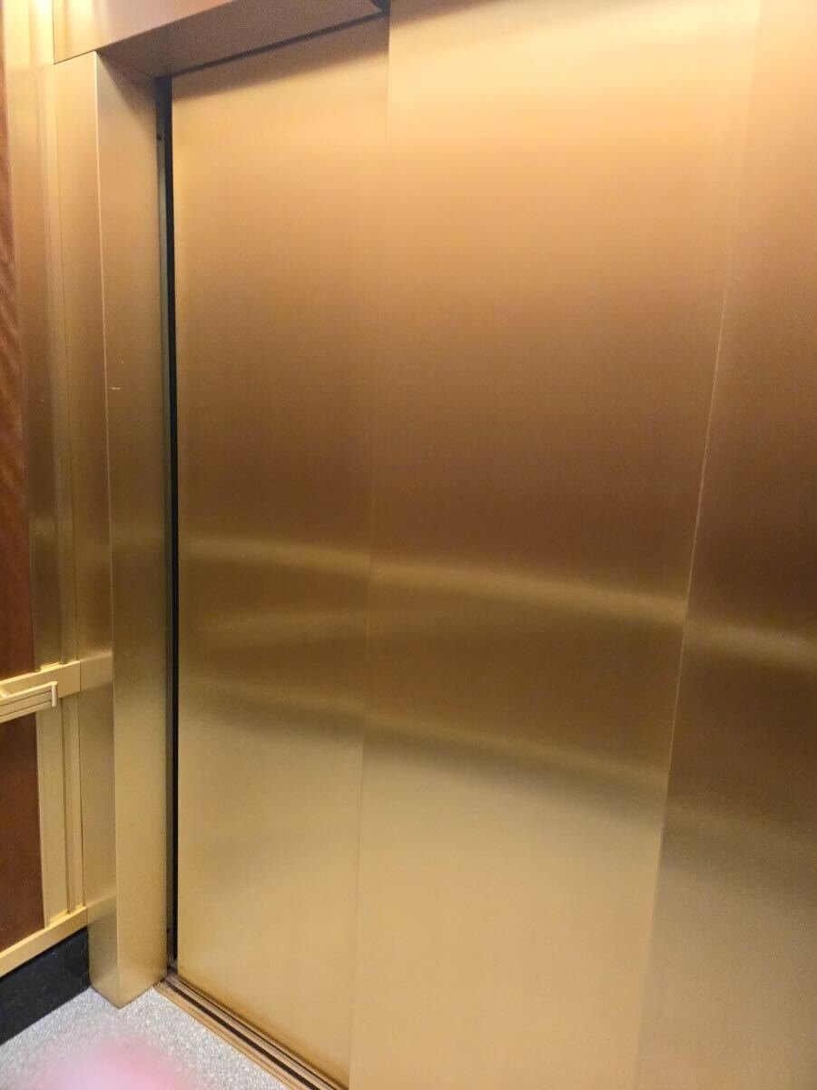 Polished brass elevator door and jamb in a government building after metal restoration by Rose Restoration