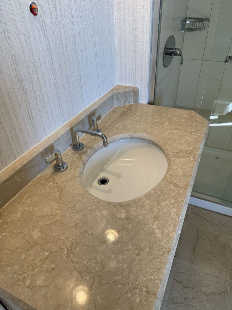 Polished hotel marble vanity after restoration