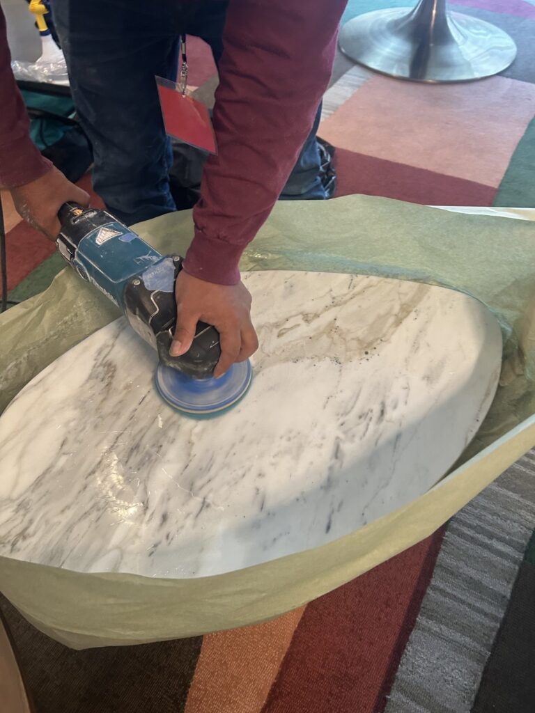 Commercial marble table top during restoration by Rose Restoration