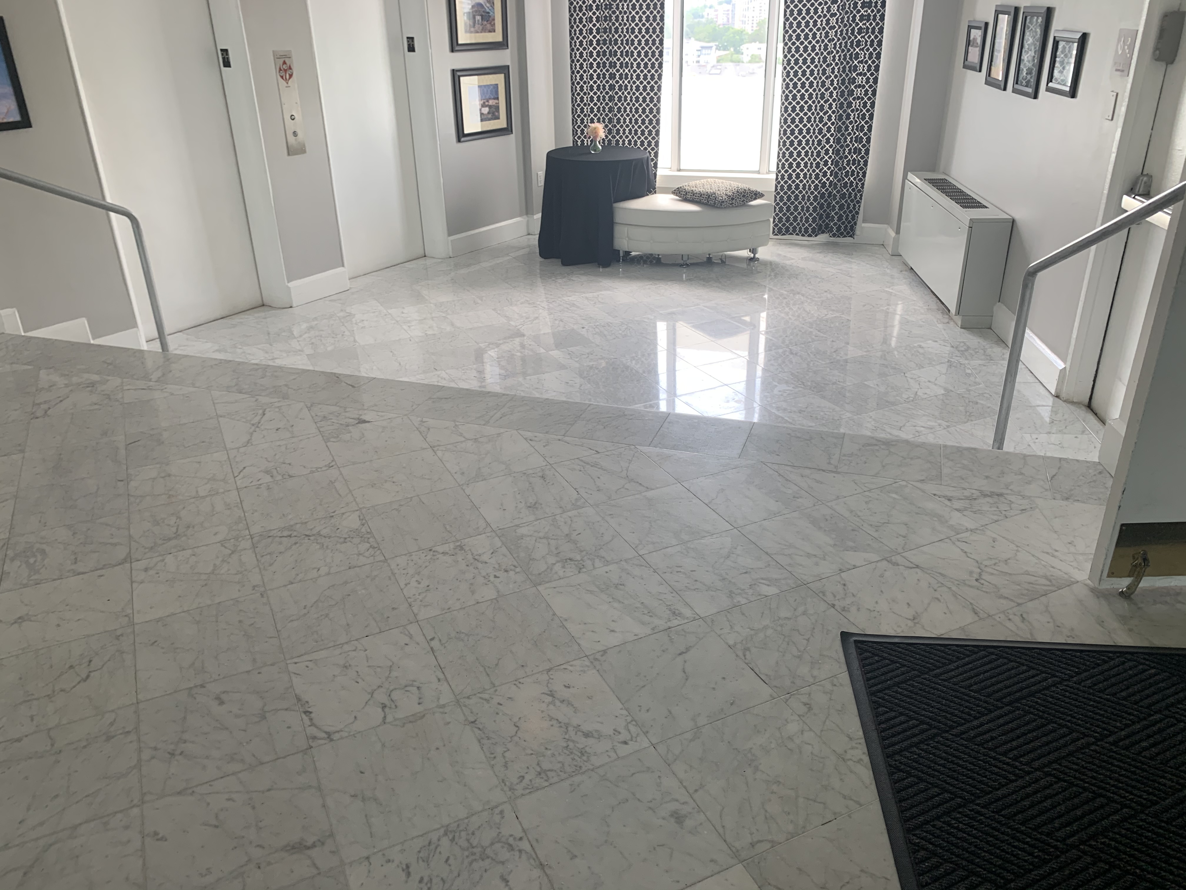 Restored white marble lobby floor with natural light by Rose Restoration