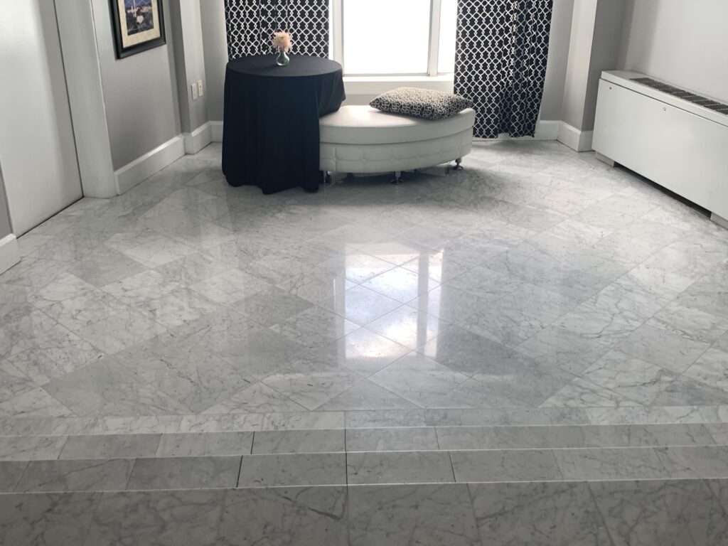 Mirror-finish polished Carrara marble floor in luxury residential lobby restored by Rose Restoration in Washington DC