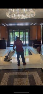 Hotel lobby marble floor restoration in progress — Rose Restoration's hospitality team