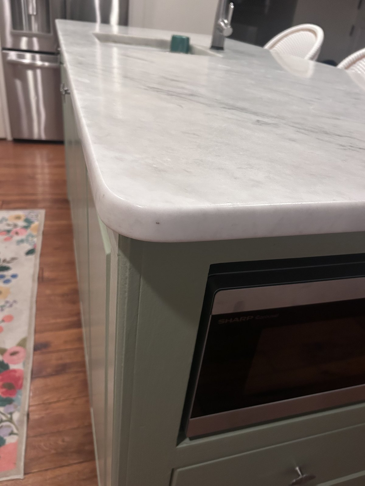 Residential marble kitchen countertop before restoration showing wear and etching
