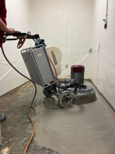 Concrete floor restoration in progress by Rose Restoration in-house crew