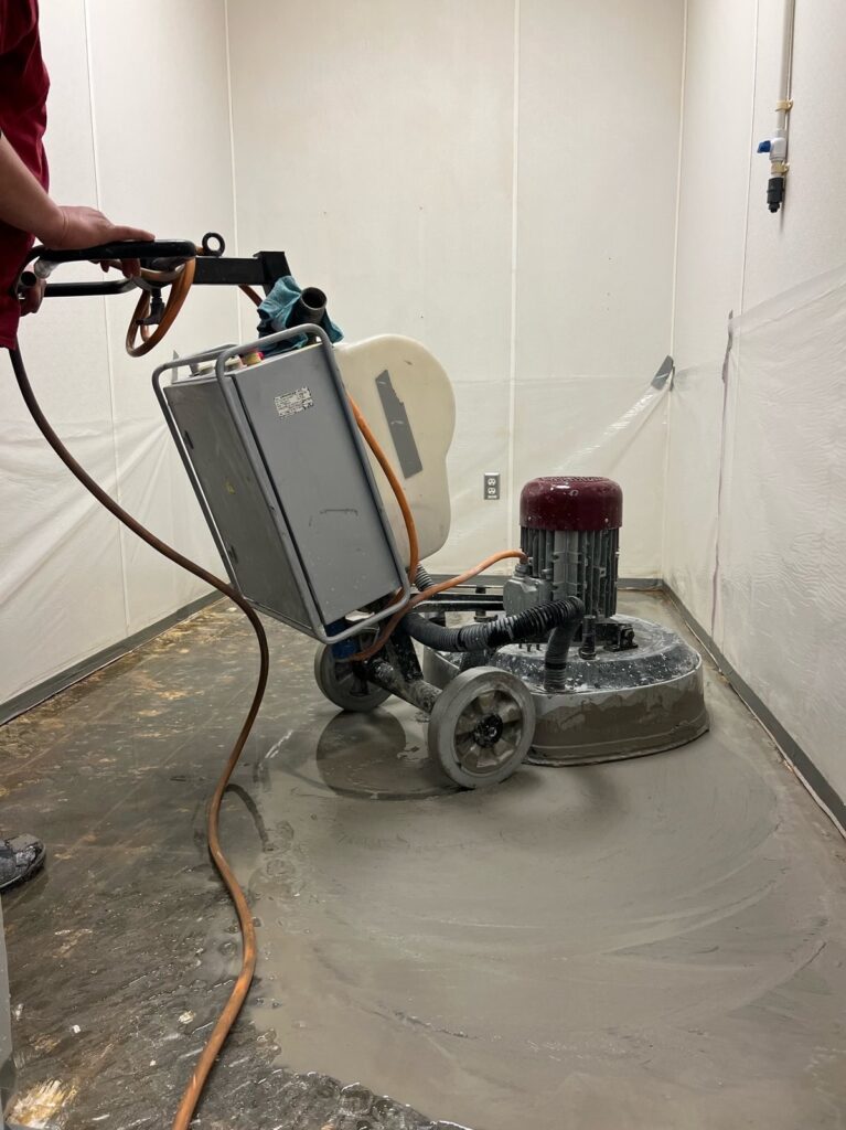 Concrete floor restoration in progress by Rose Restoration in-house crew