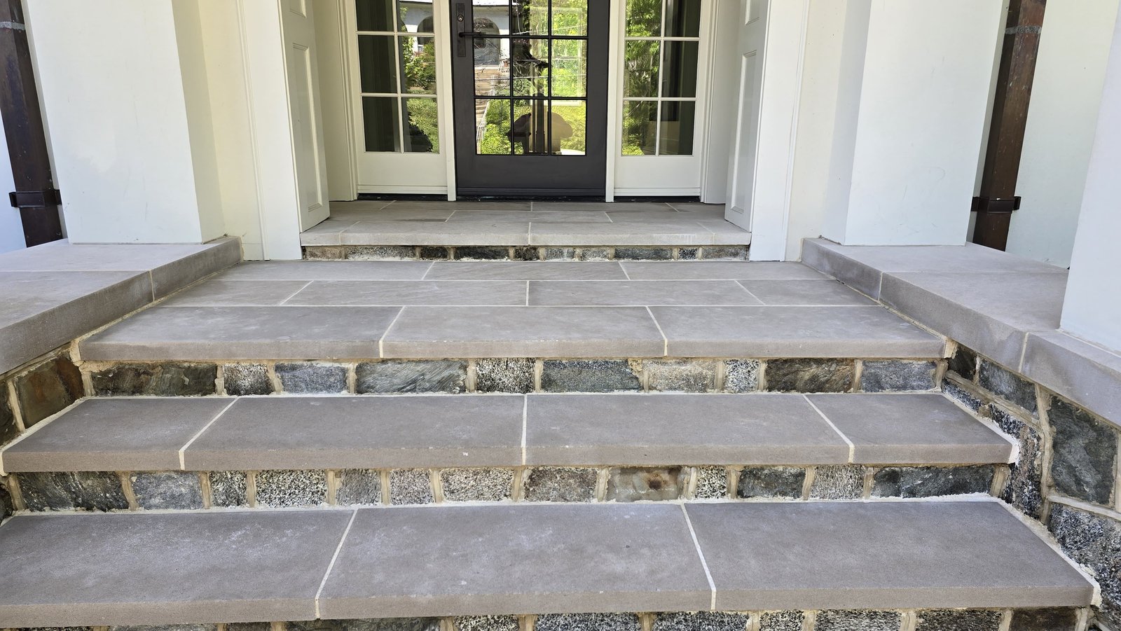 Restored bluestone stair treads at residential entry