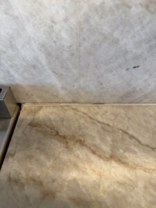 Commercial restroom marble wall panels during restoration by Rose Restoration