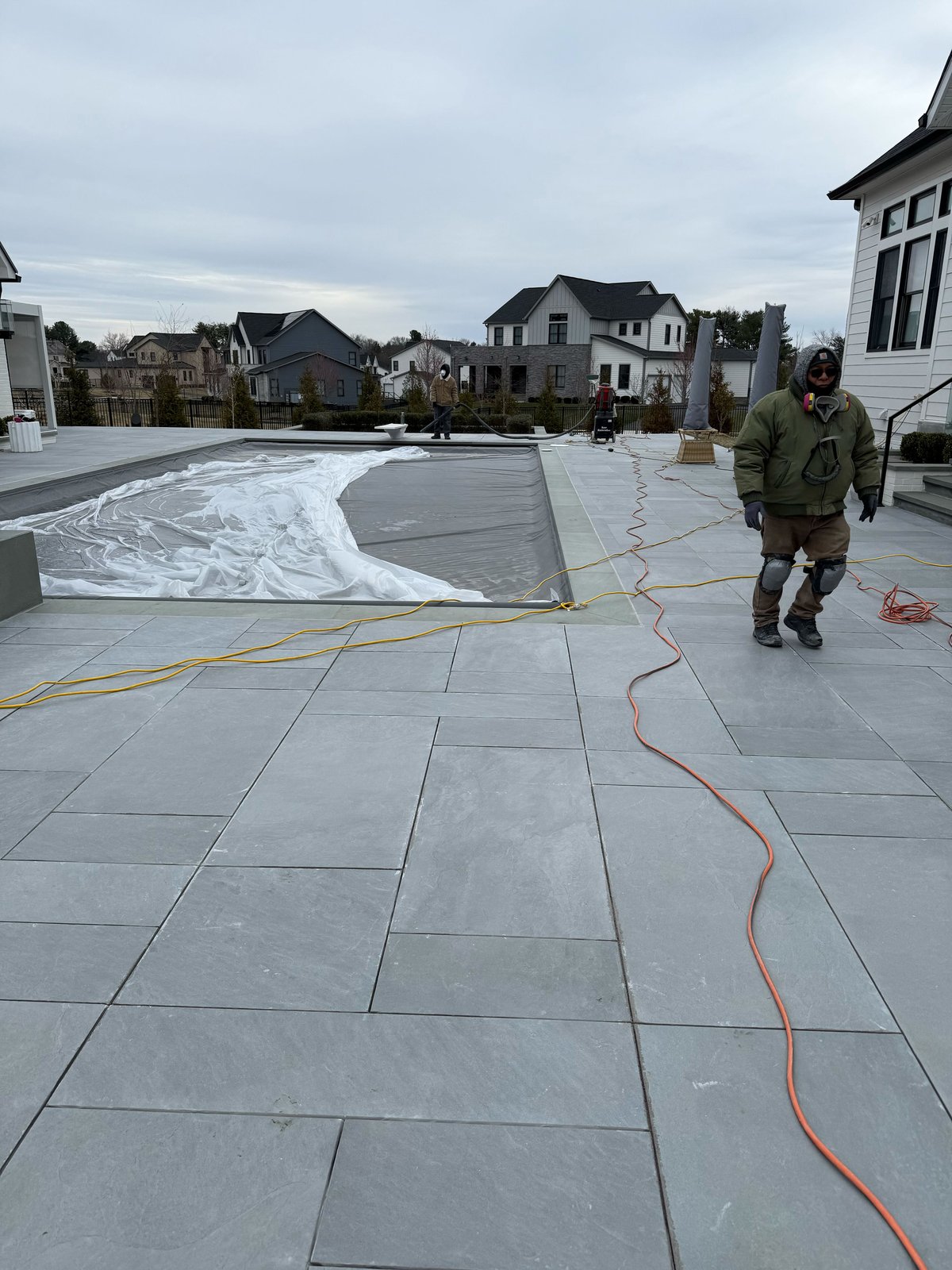 Travertine pool deck restoration in progress at residential property by Rose Restoration