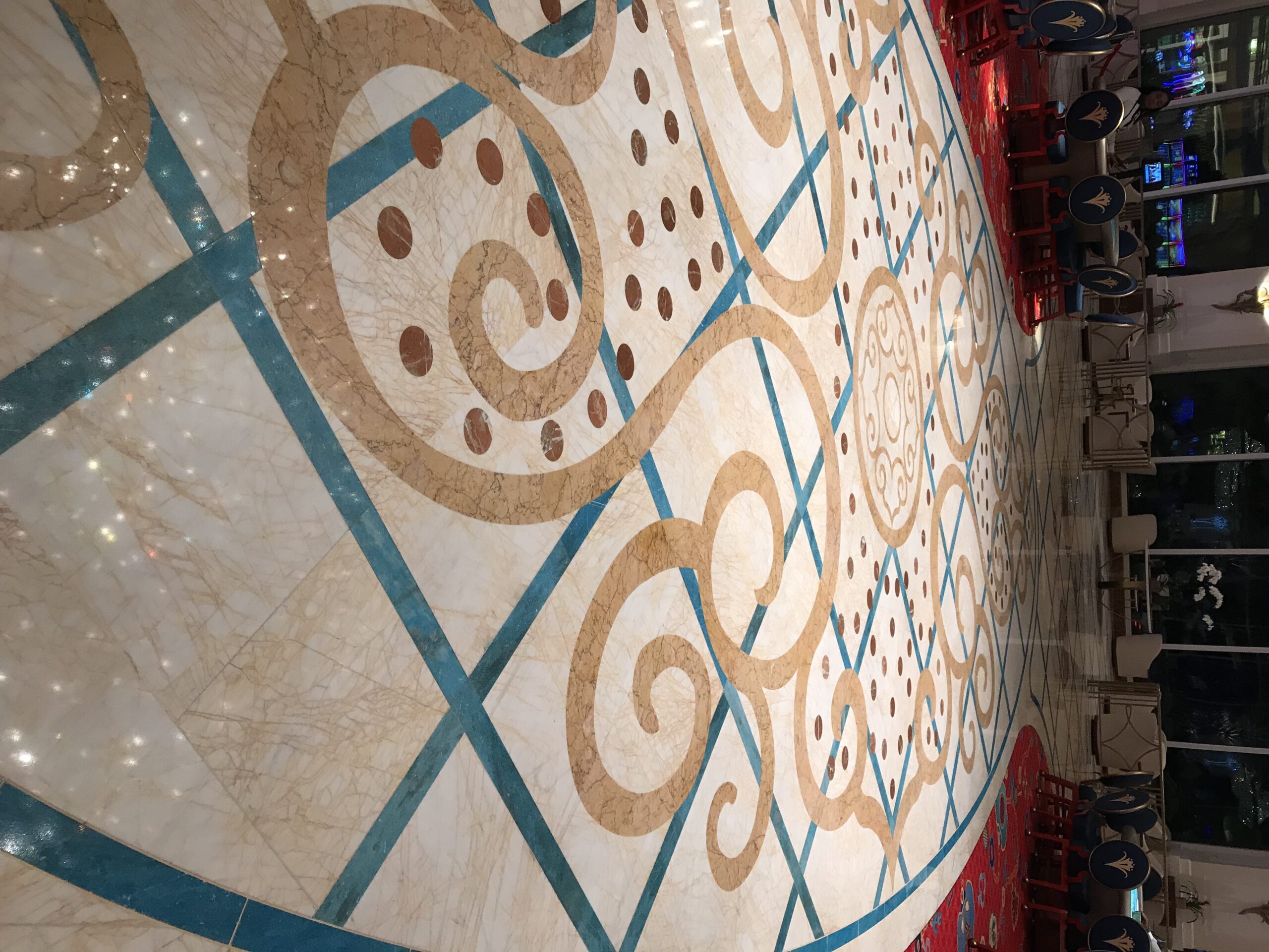 Decorative marble inlay floor with scrollwork and coloured stone banding, polished by Rose Restoration