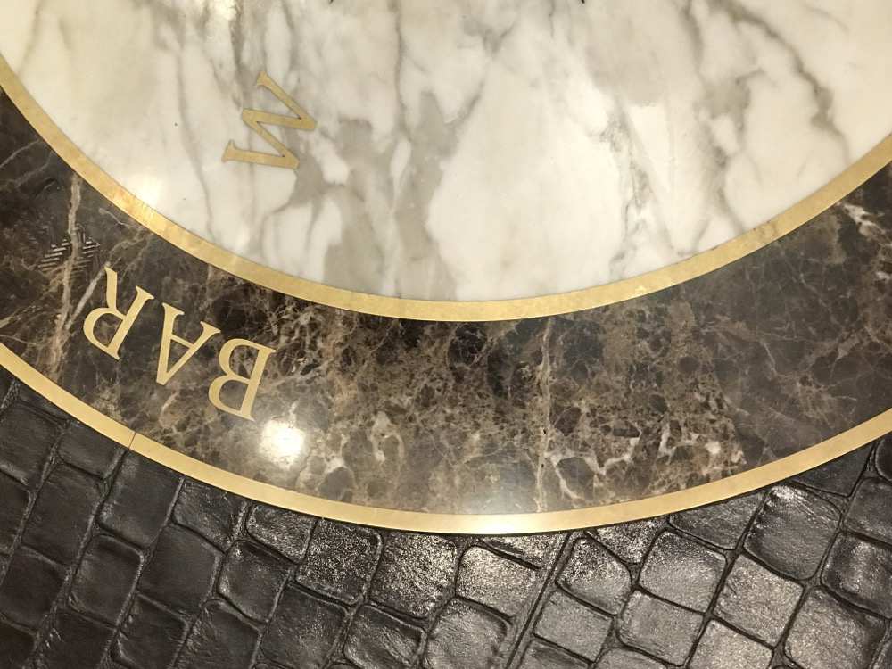 Brass inlaid marble bar medallion with Calacatta and Emperador stone at Baha Mar, detailed by Rose Restoration