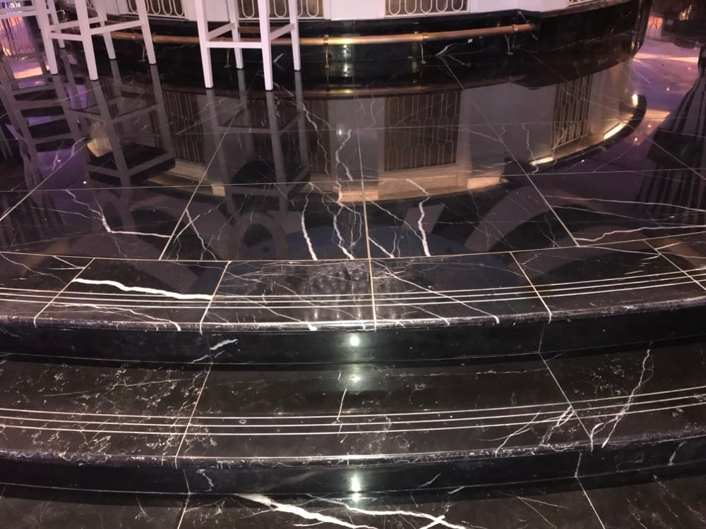 Mirror finish black marble curved bar steps at Baha Mar by Rose Restoration