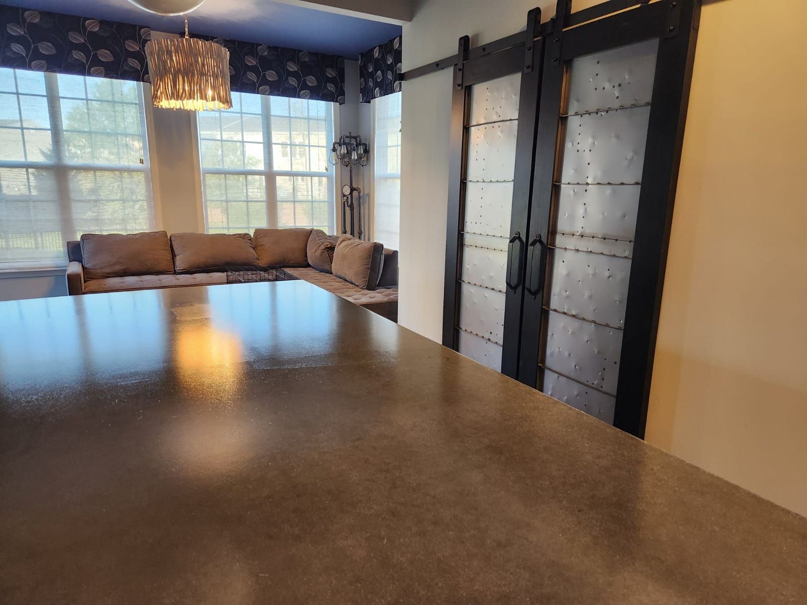 Polished stone floor in an amenity lounge with seating and full height windows