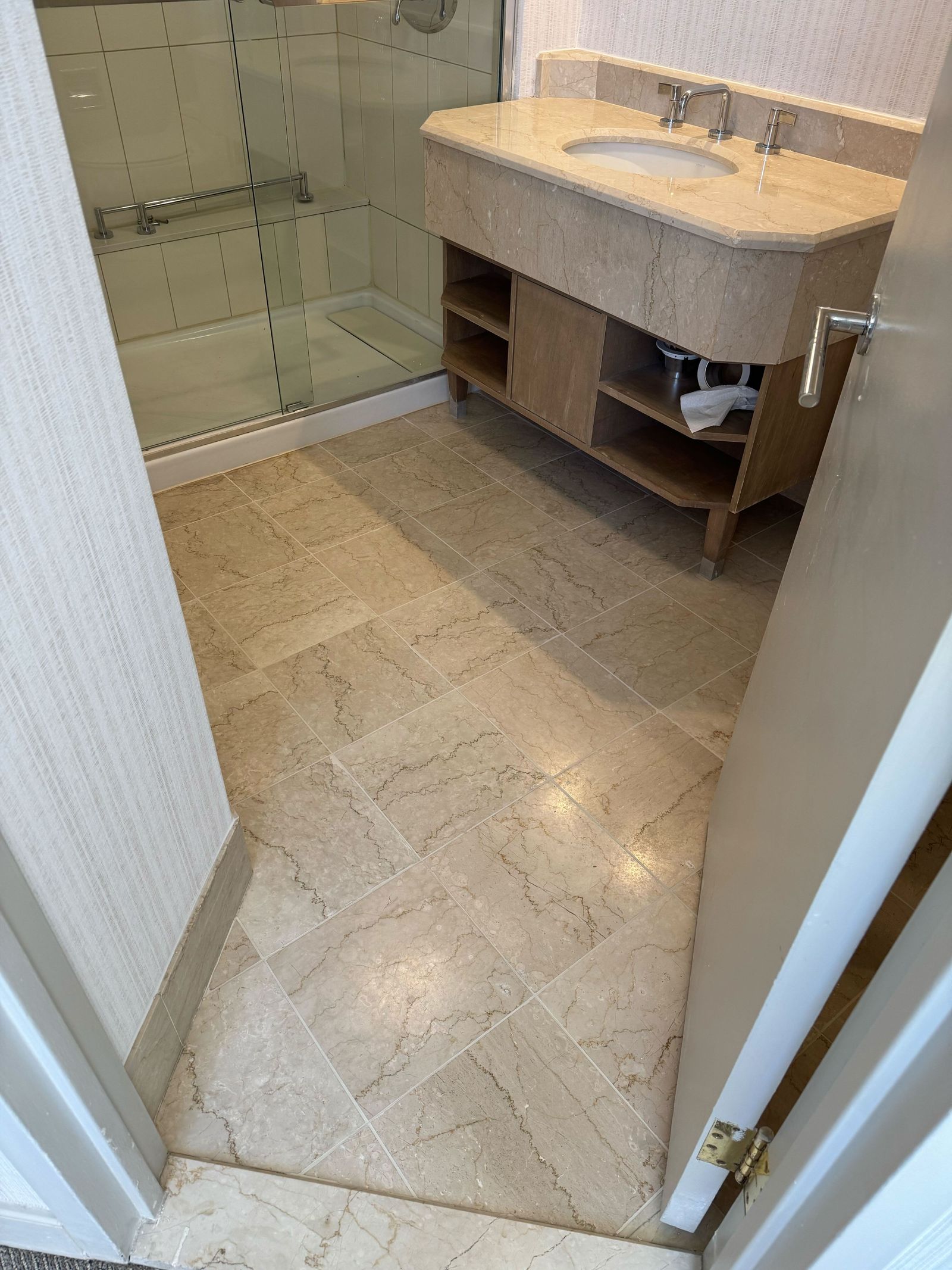 Restored stone bathroom floor in an Alexandria hotel guest room