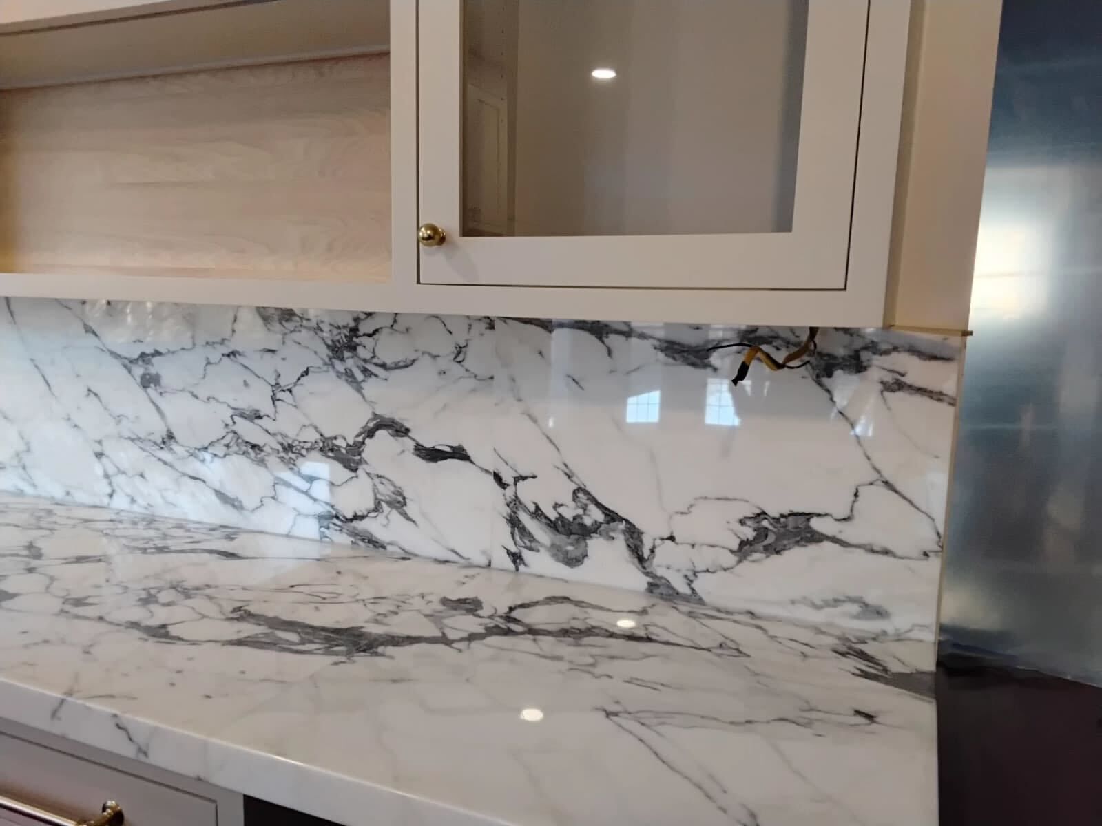 Polished Calacatta marble countertop in a residential kitchen by Rose Restoration