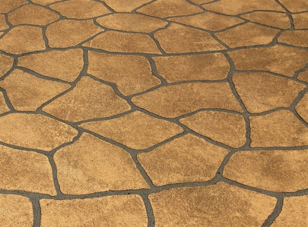Stenciled decorative concrete floor finished by Rose Restoration