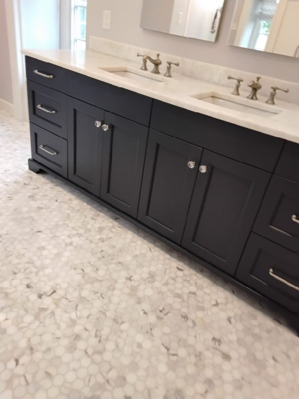 Rose Restoration technician polishing a marble table top under floor protection