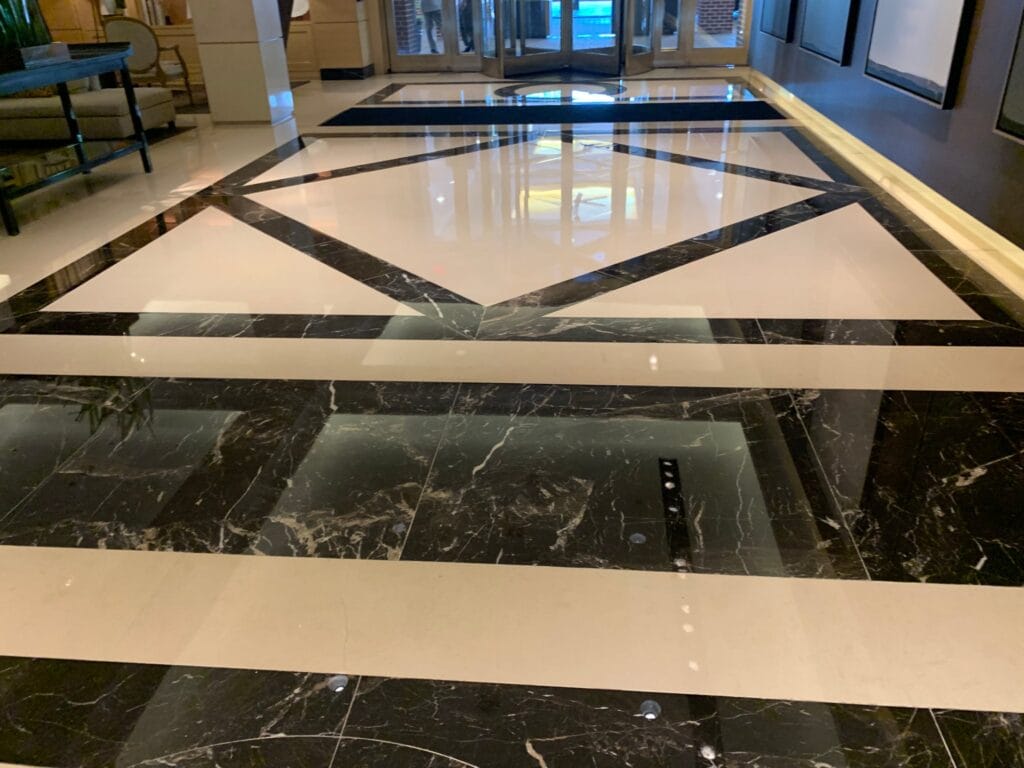 Black and white marble floor with inlaid borders, polished