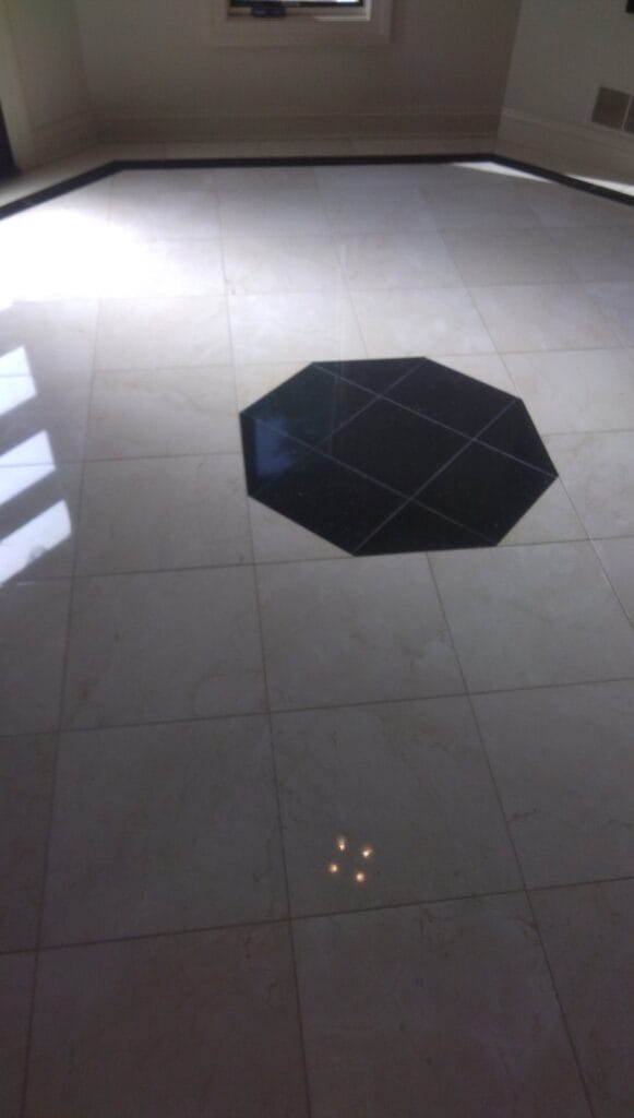 Black stone floor with an inlay from a Rose Restoration job in Potomac, MD