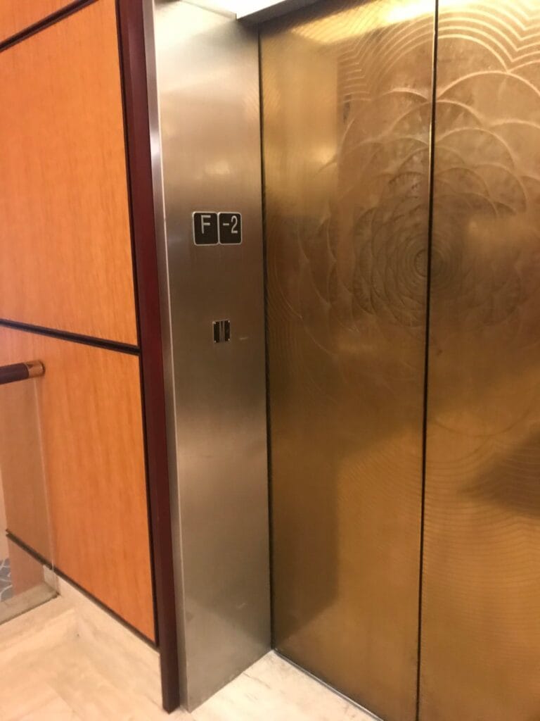 Bronze elevator doors and wood paneling, refinished