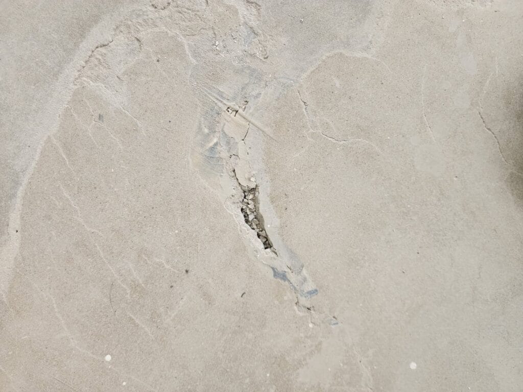 Chipped and cracked area in a pale marble surface