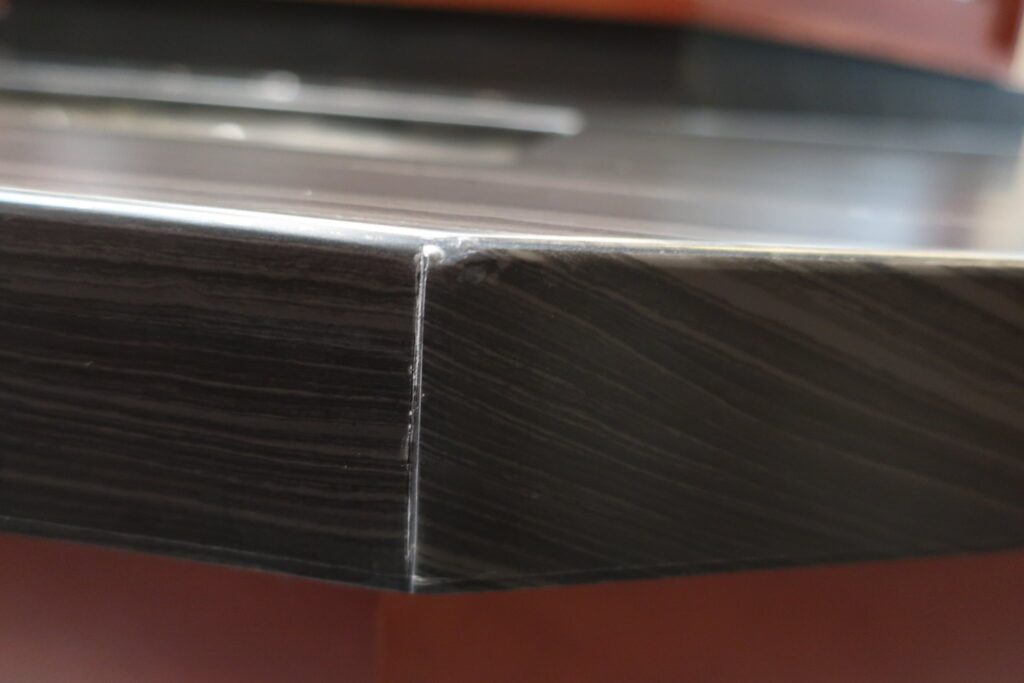 Chipped edge of a dark stone countertop