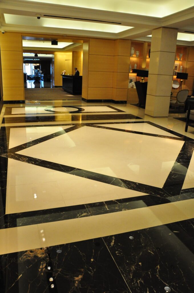 Cream marble lobby floor with a black border