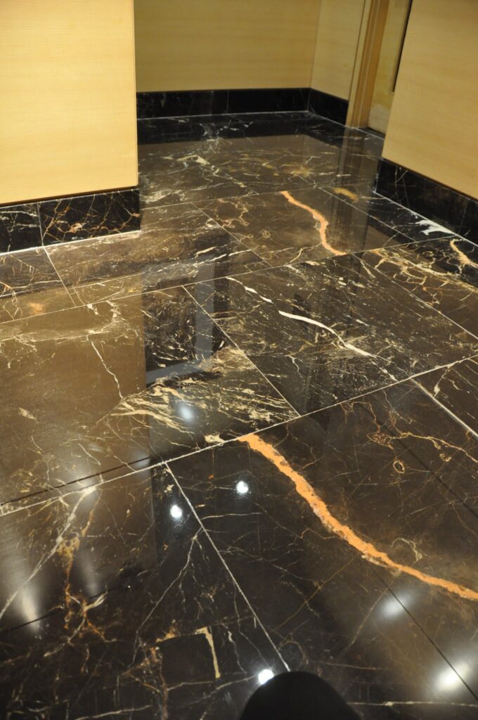 Polished black and gold veined marble corridor floor at the Four Seasons Hotel in Washington, DC