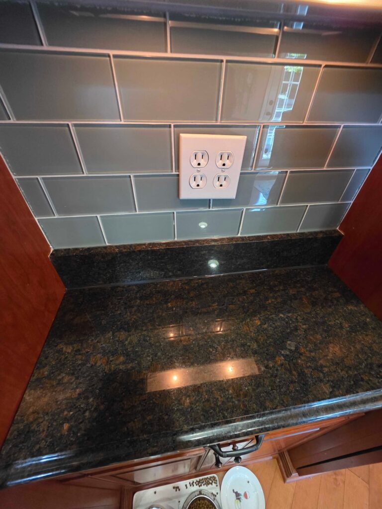 Granite countertop with tiled backsplash from a Rose Restoration job in McLean, VA