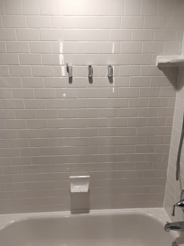 Hotel guest bathroom subway tile tub surround from a Rose job in College Park, MD