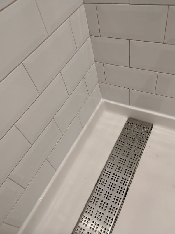 Hotel shower with subway tile and a linear drain from a Rose job in College Park, MD