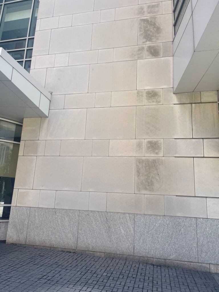 Limestone building facade during cleaning