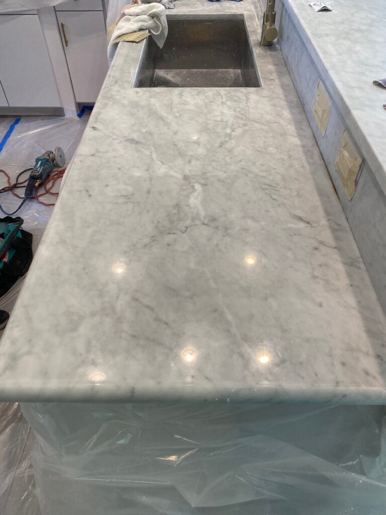 Marble countertop polished, with cabinets protected during work