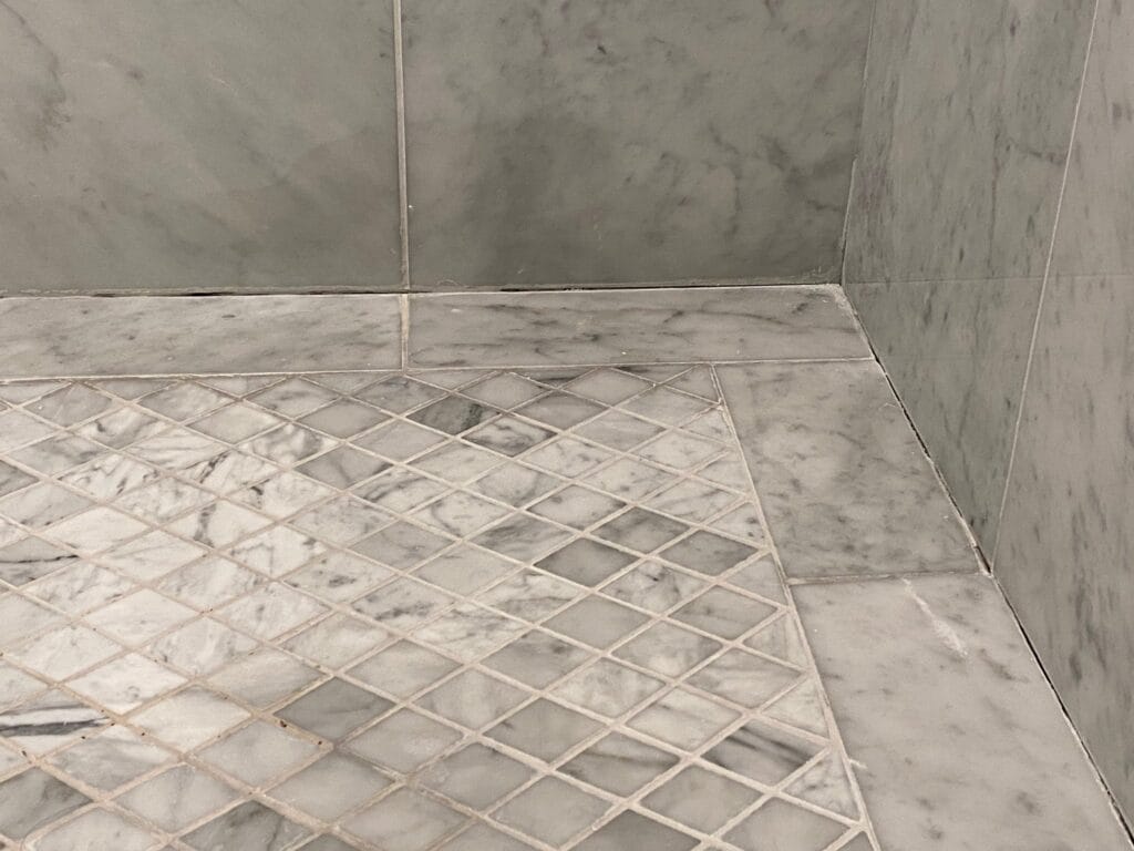 Marble mosaic shower floor with clean grout
