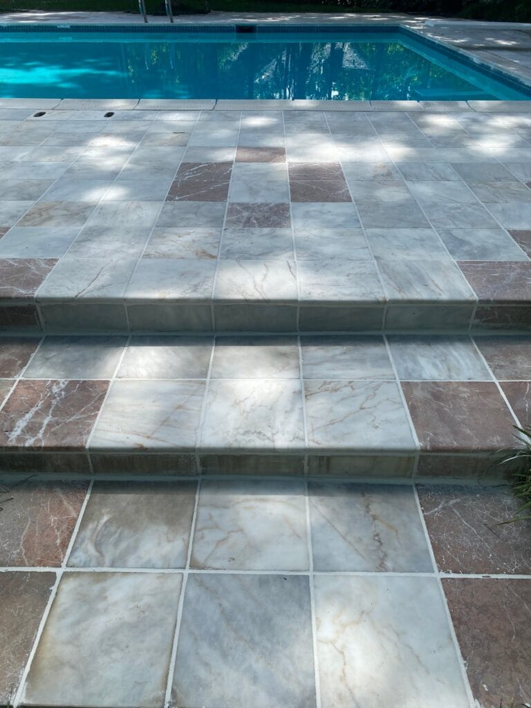 Marble pool deck with an inlaid pattern