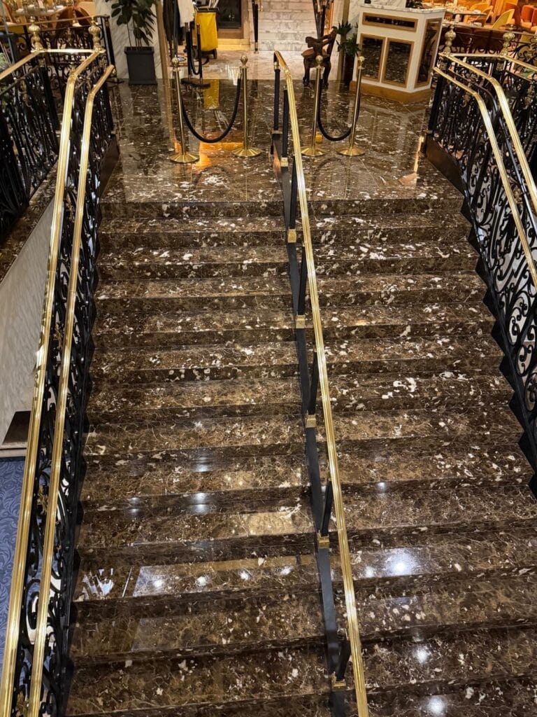 Marble staircase with polished brass railings